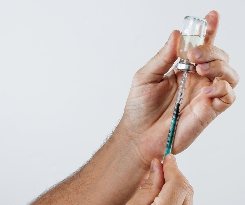 filling a syringe with injection